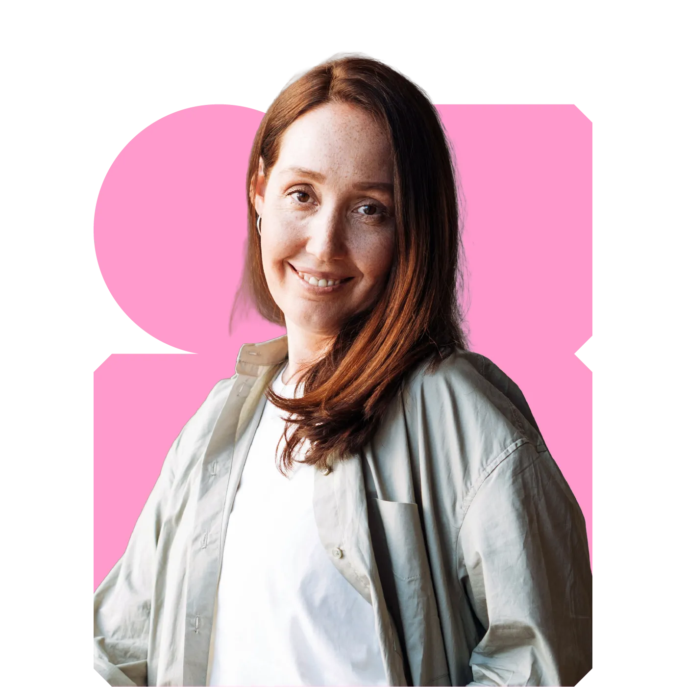 Smiling red-haired woman in a white T-shirt and light overshirt, portrait against a pink graphic background